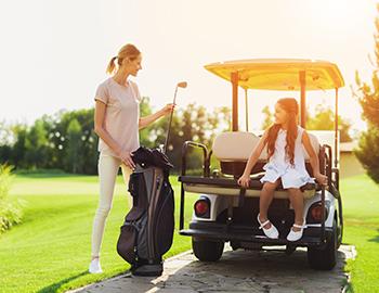 Mother golfing with daughter