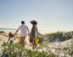A family walks to the beach in Gulf Shores, AL