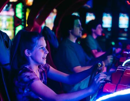 Kid playing arcade game