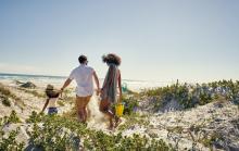 A family walks to the beach in Gulf Shores, AL