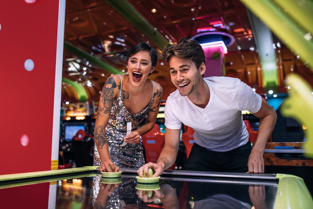 Couple playing air hockey
