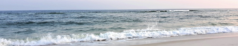 A wave crashing on a beach near Gulf Shores