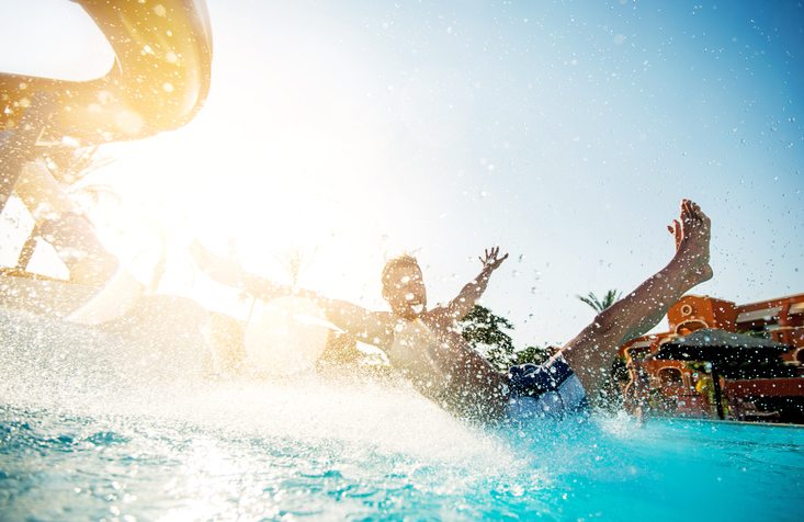 A man comes out of a water slide