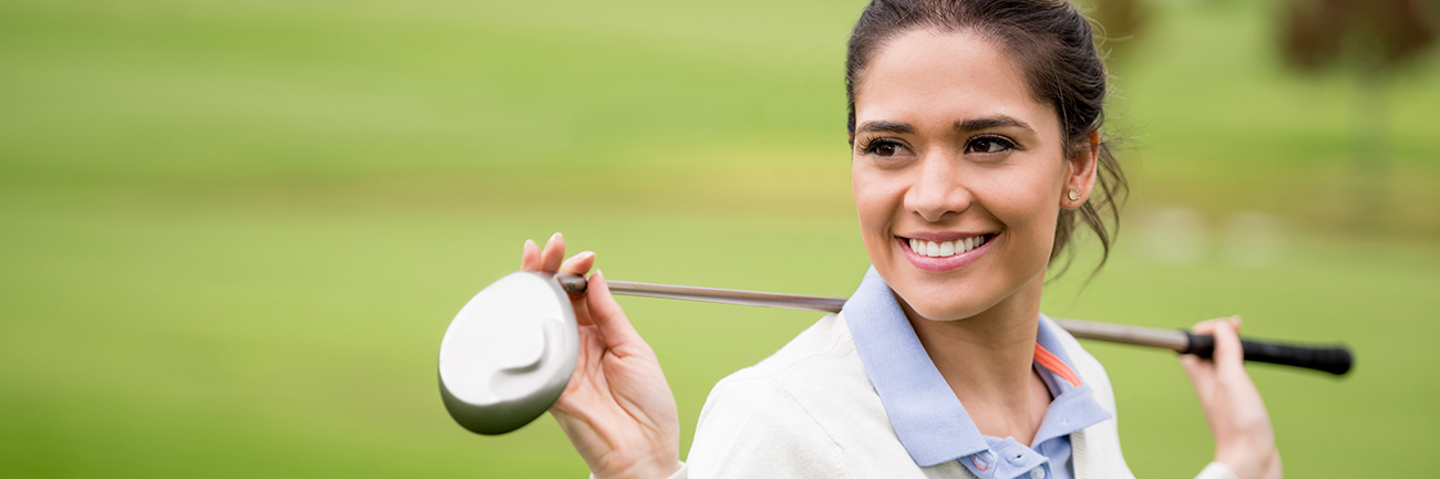 Woman holding golf club over shoulders