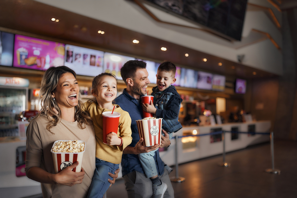 family going to a movie in a theater