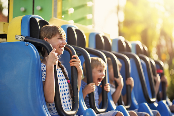 A mother and son ride an amusement ride